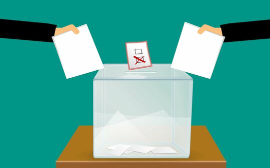 Dessin illustrant un vote (urne et bulletins)